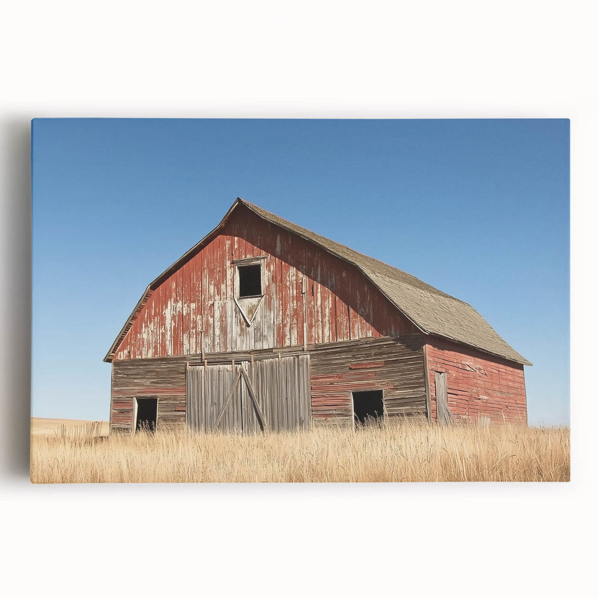 Stretched canvas print showcasing a vibrant landscape of a rustic barn set against a colorful sunset, ideal for farmhouse decor and nature enthusiasts.