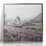 Framed wall art depicting a serene countryside landscape, featuring vibrant green fields and a clear blue sky, displayed in a sleek silver-acrylic frame.