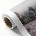 Landscape wall art on rolled canvas depicting a serene countryside scene with vibrant greens and a blue sky, elegantly packaged in a protective cardboard tube.