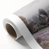 Landscape wall art on rolled canvas depicting a serene countryside scene with vibrant greens and a blue sky, elegantly packaged in a protective cardboard tube.