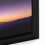 Close-up of a framed canvas artwork depicting a serene desert landscape, showcasing warm earthy tones and intricate details of sand dunes and blue sky, perfect for home decor.