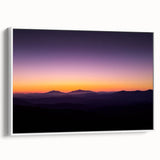 Framed canvas artwork depicting a vibrant desert landscape with warm earthy tones, showcasing rolling dunes and a bright blue sky, ideal for home decor.