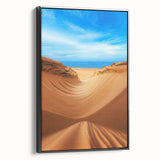 Framed canvas artwork showcasing serene desert dunes in warm earth tones, set against a black frame, perfect for modern home decor and enhancing aesthetic appeal.