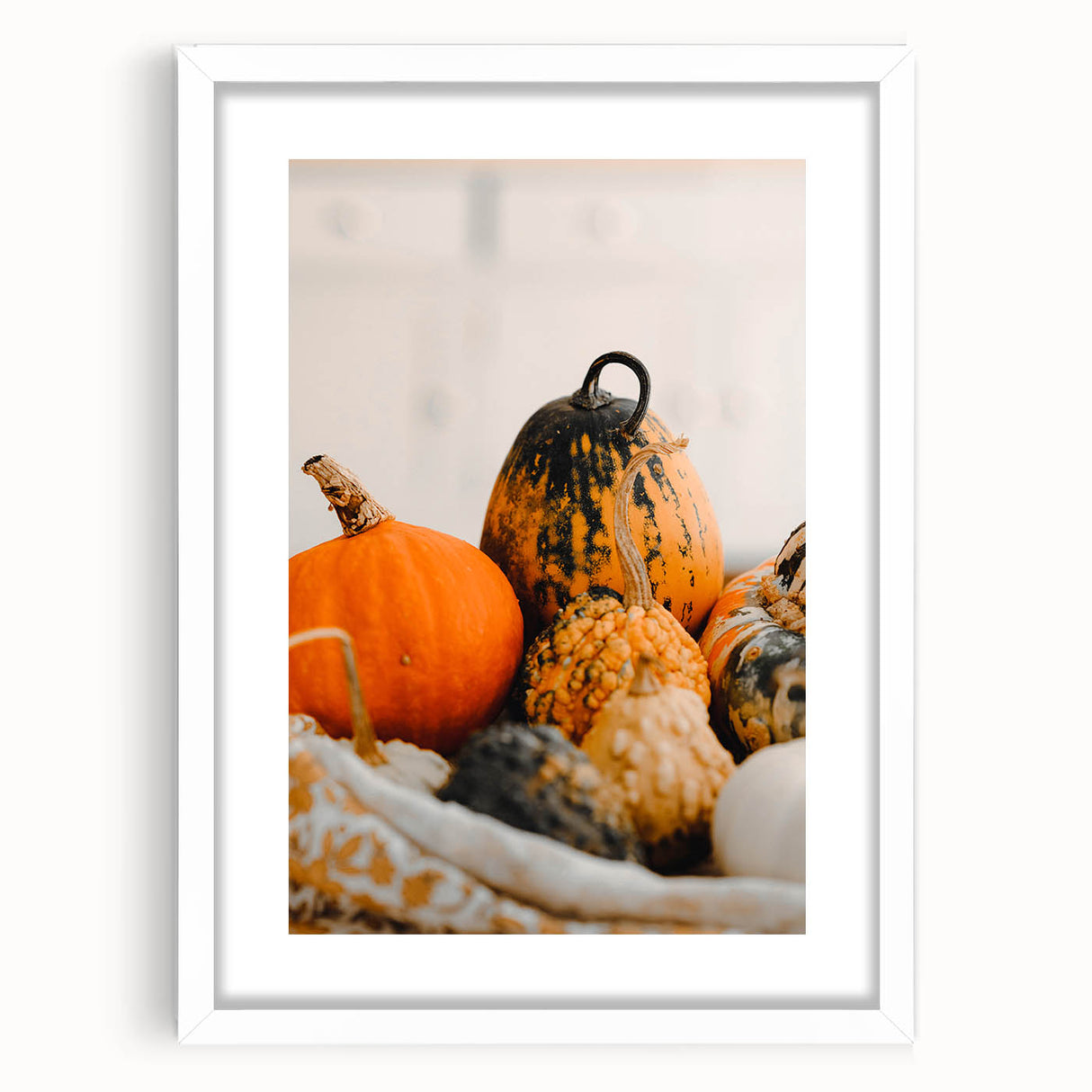 Abstract art print featuring swirling autumn colors in a white frame, suitable for bedroom or dining room decor.
