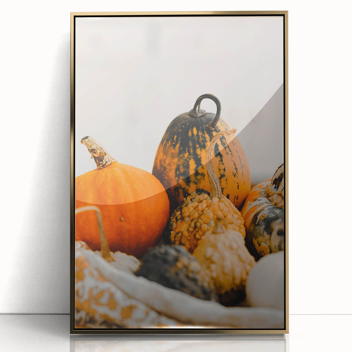 Large art print of a mid-century modernist autumn scene in gold and orange tones on a framed acrylic.