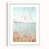 Abstract art print featuring fluid blue and green shapes on a white framed canvas, suitable for dining room or bedroom decor.