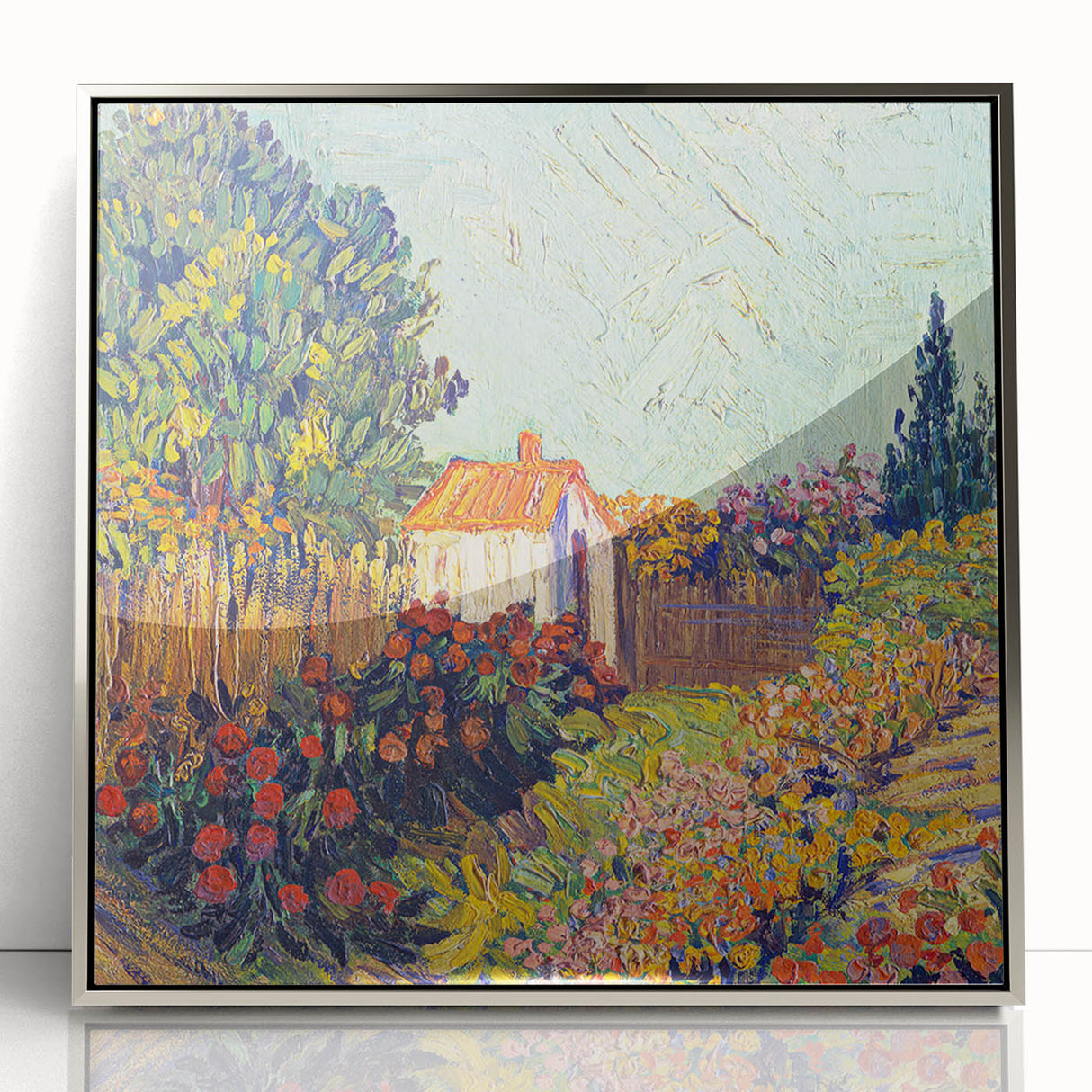 Large art print of Van Gogh's Starry Night in a silver frame, featuring swirling blues and yellows.