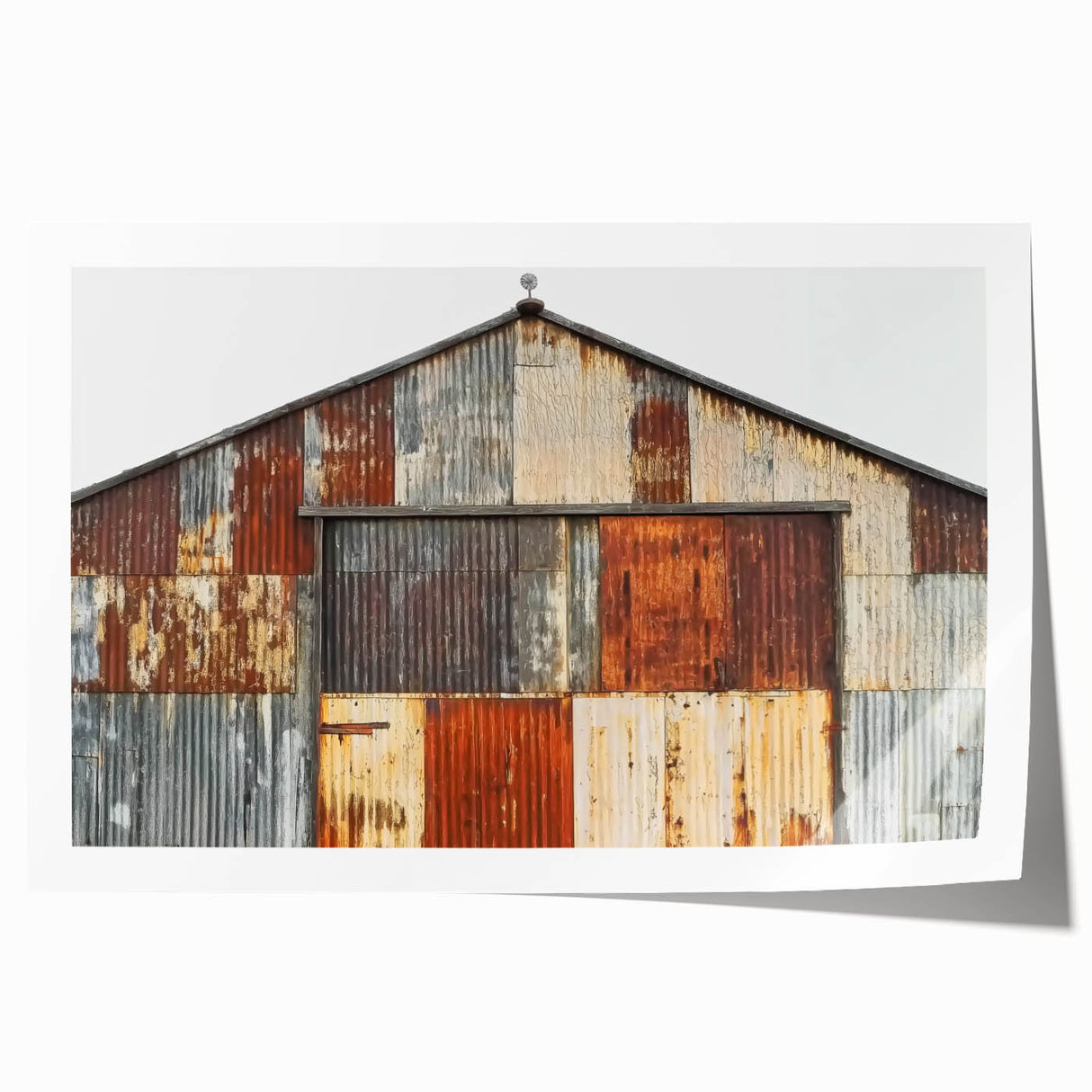 Landscape barn art print showcasing a rustic scene with a weathered barn, vibrant green fields, and a clear blue sky, rolled and ready for framing or display. Perfect for farmhouse decor enthusiasts seeking a touch of countryside charm.