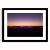 Black-framed landscape artwork depicting a desert scene, featuring warm tones of orange and beige. Ideal for modern home decor, adding a touch of nature's beauty.