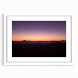 Framed desert landscape artwork with a white mat, showcasing vibrant colors and intricate details, perfect for home decor or office styling.