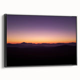 Framed canvas artwork depicting a serene desert landscape in warm tones, featuring cacti and mountains, presented in a sleek black frame, ideal for modern decor.