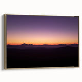 Framed canvas artwork showcasing a vibrant desert landscape with warm gold tones, perfect for home decor, displayed at an angle to highlight its elegant frame.