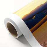 Rolled canvas artwork showcasing a serene desert landscape with gentle sand dunes under a vibrant sunset, delivered in protective cardboard packaging.