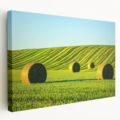 Stretched canvas artwork showcasing a vibrant landscape with rolling fields under a bright blue sky, perfect for adding a serene touch to home decor.