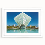 Abstract art print depicting a stylized Brazilian landscape in vibrant green and blue tones on a framed white mat.
