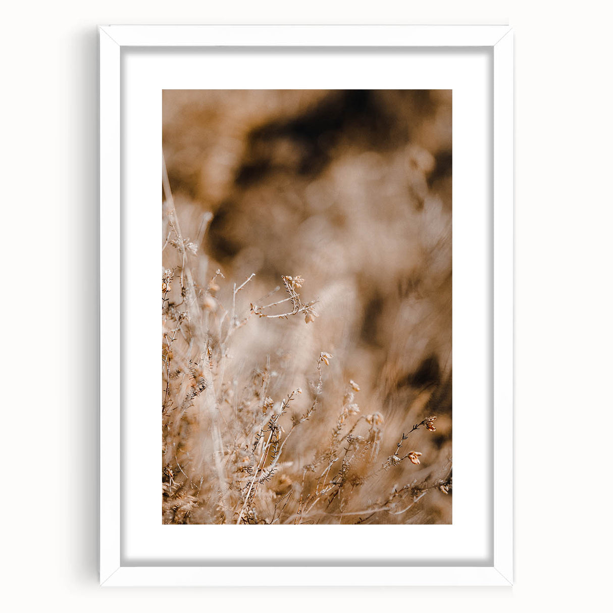 Abstract art print featuring warm autumnal hues on a white framed canvas, suitable for bedroom or dining room decor.