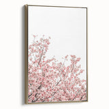 Framed canvas featuring a vintage poster art style landscape painting with spring motifs in muted green and gold.