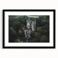 Black-framed landscape artwork featuring a medieval castle surrounded by lush greenery, elegantly matted for a sophisticated presentation. Perfect for enhancing home decor.