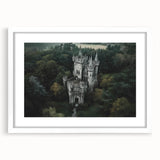 Elegant white-framed landscape artwork featuring a majestic castle surrounded by lush greenery, suitable for home decor or office spaces, enhancing ambiance with classic charm.