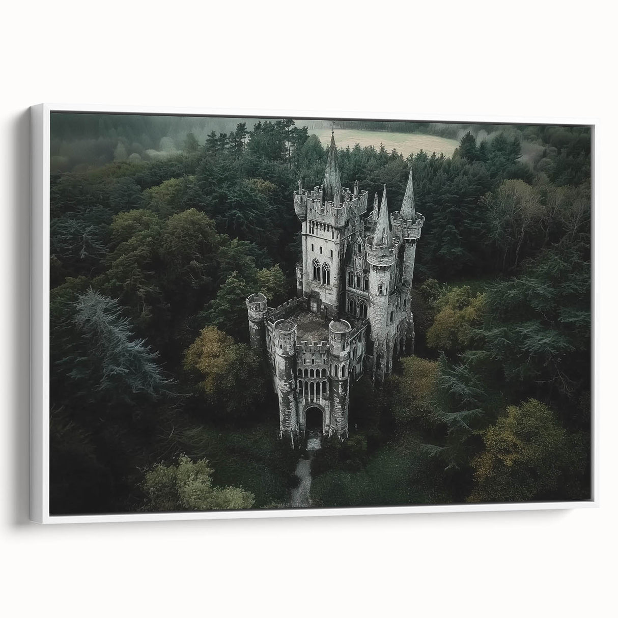 Framed canvas artwork depicting a picturesque landscape with a medieval castle surrounded by lush greenery, showcased in a white frame from a side view. Ideal for enhancing home decor with a touch of elegance and historical charm.