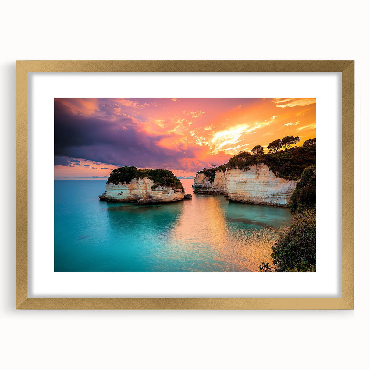 Gold-framed landscape print featuring dramatic cliffs and serene ocean waves, accented with a white mat for an elegant presentation, ideal for home decor.