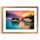 Gold-framed landscape print featuring dramatic cliffs and serene ocean waves, accented with a white mat for an elegant presentation, ideal for home decor.