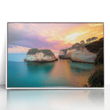 Framed acrylic artwork depicting dramatic coastal cliffs at sunset, featuring vibrant colors and intricate details, perfect for enhancing modern home decor.