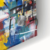 Close-up of an abstract acrylic artwork with vibrant blue and orange splatters on glass, showcasing a modern artistic design ideal for contemporary decor.