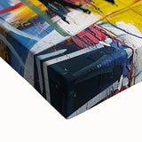 Close-up view of a vibrant abstract splatter canvas artwork showcasing bold colors like blue, yellow, and red, ideal for modern home decor or art collection.