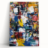 Abstract splatter art on stretched canvas showcasing vibrant hues of blue, orange, and yellow, leaning against a neutral wall, perfect for modern home decor.