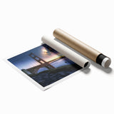 Landscape bridge rolled print showcasing a serene river scene with lush greenery and a clear blue sky, packaged securely in a protective cardboard tube for easy transport.