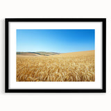 Black-framed landscape artwork showcasing a serene countryside scene, featuring vibrant greens and blues, ideal for home decor or office ambiance.