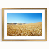 Elegant gold-framed landscape artwork depicting a serene countryside scene, complete with a mat for an enhanced display, ideal for home decor and wall aesthetics.