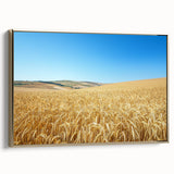 Framed canvas artwork depicting a serene countryside landscape with golden accents, showcasing lush green fields and a clear blue sky, ideal for home decor.