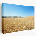 Stretched canvas artwork depicting a serene countryside landscape, showcasing lush green fields, rolling hills, and a bright blue sky, ideal for home decor.