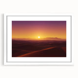 Desert landscape artwork framed in a white mat, showcasing vibrant orange and yellow hues of sunset over sand dunes, ideal for modern home decor.