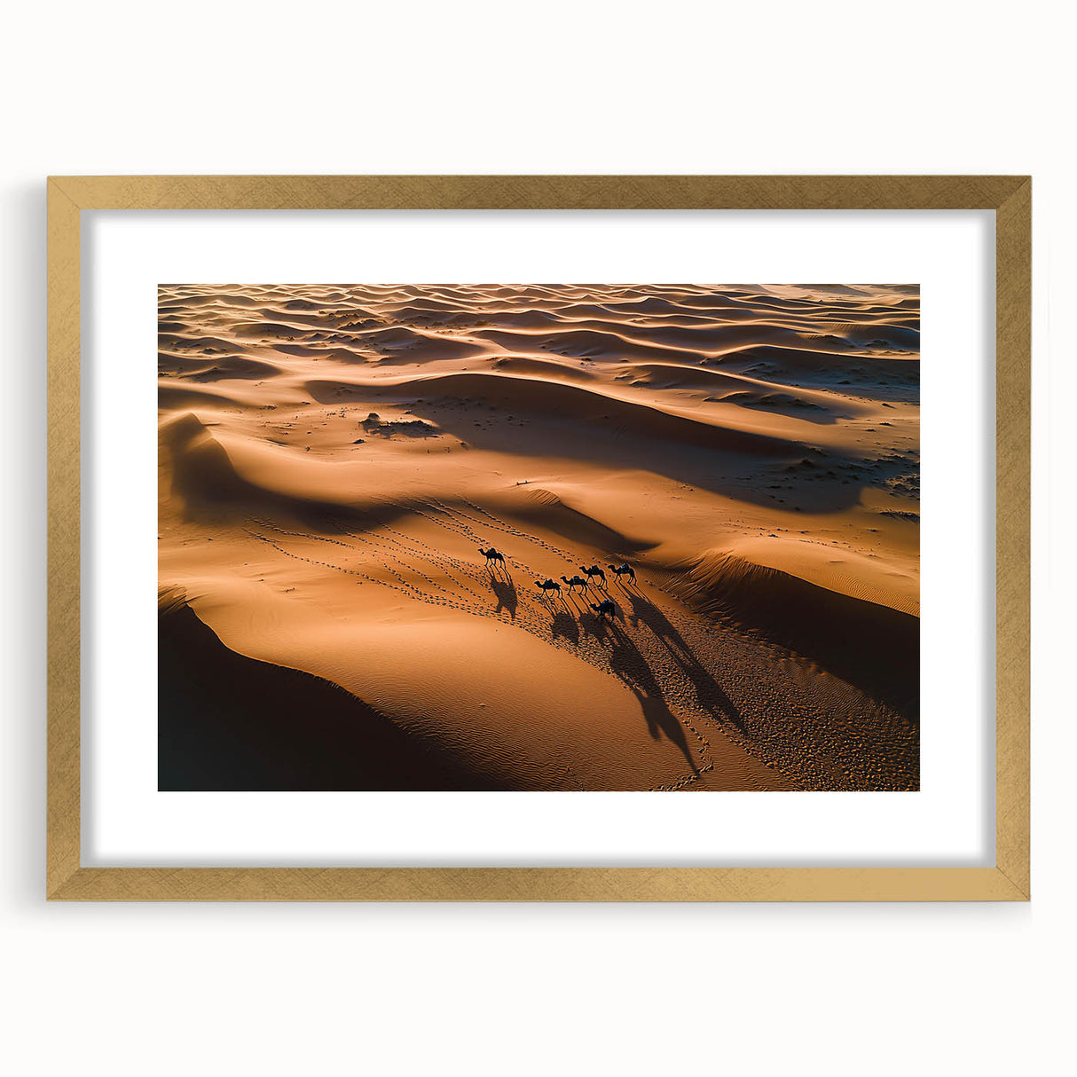 Framed landscape artwork of serene sand dunes, featuring a gold mat and elegant frame, ideal for home decor, adding warmth and sophistication to any room.
