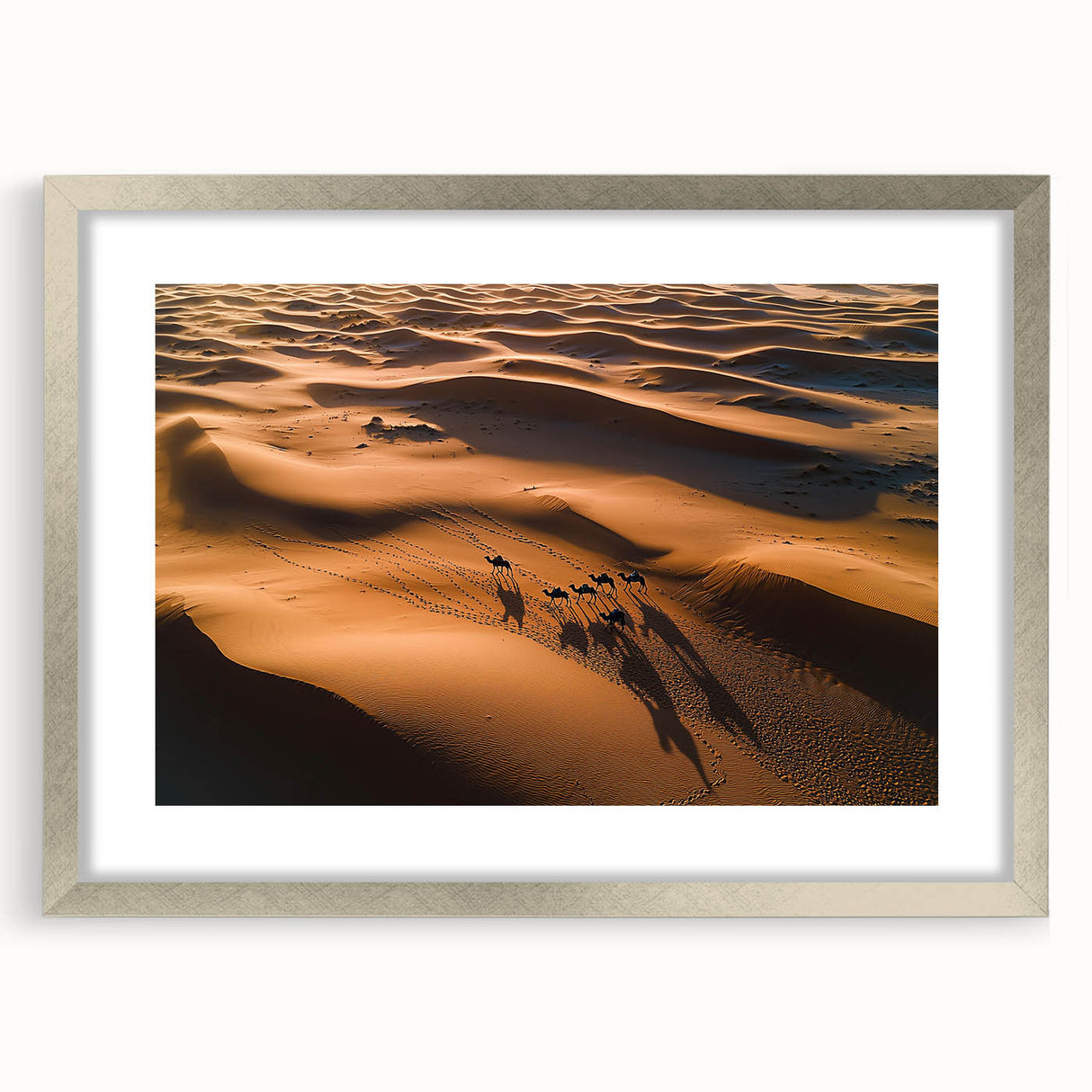 Framed landscape art print showcasing serene sand dunes in soft beige and gold tones, elegantly displayed with a silver mat, perfect for modern home decor.