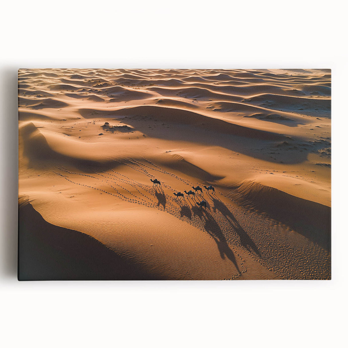 Stretched canvas artwork depicting a serene desert landscape with rolling dunes under a clear blue sky, perfect for home decor and art enthusiasts.