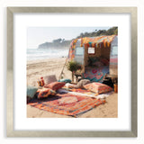 Textured art print featuring an abstract caravan in muted earth tones on a framed silver mat, suitable for bedroom decor.