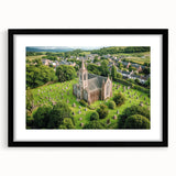 Elegant black-framed landscape artwork showcasing a majestic castle surrounded by lush greenery, presented with a mat for a refined finish. Perfect for home decor.