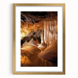 Elegant gold-framed landscape artwork showcasing intricate cave formations, complete with a mat for added depth, ideal for enhancing home decor aesthetics.