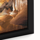 Close-up of a framed canvas depicting a serene landscape with intricate cave formations, showcasing earthy tones and detailed textures, perfect for home decor.