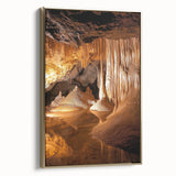 Framed canvas artwork showcasing a stunning landscape with dramatic caves, highlighted by a gold border; perfect for enhancing modern interior decor.