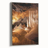 Framed canvas artwork showcasing a stunning landscape with intricate cave formations, highlighted by a sleek silver frame, perfect for home decor.