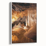 Framed canvas depicting a serene landscape scene with caves, featuring soft hues of blue and beige, elegantly displayed against a white backdrop. Ideal for enhancing modern home decor.