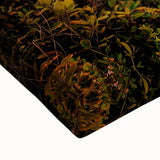 Close-up of a stretched canvas art piece showcasing dramatic cliffs and vibrant landscapes, highlighting intricate brushwork and rich colors, perfect for home decor.