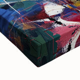 Colorful abstract splatter art on stretched canvas, showcasing vibrant hues of blue, orange, and yellow, perfect for modern home decor or artistic spaces.