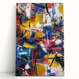 Abstract splatter art canvas in vibrant blue, yellow, and red hues, leaning against a white wall, ideal for modern interior decor, adding a splash of color and creativity.
