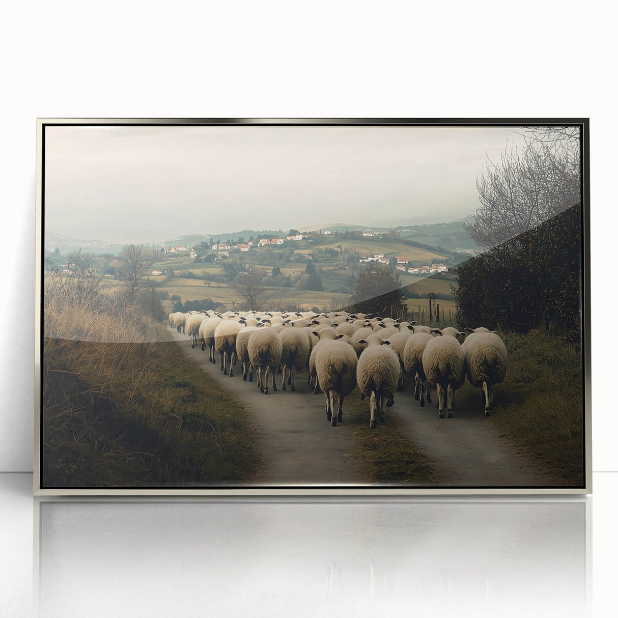 Framed acrylic artwork showcasing a serene countryside landscape with rolling hills and lush greenery, accented by a sleek silver frame for modern decor appeal.